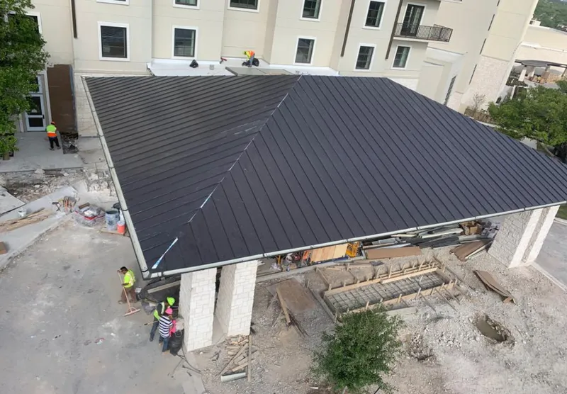 Metal roofing installation team working on a commercial building in La Plata